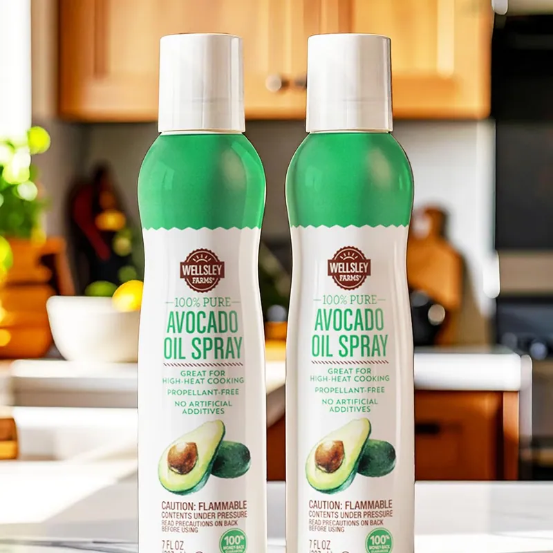 Two cans of Wellsley Farms Avocado Oil Spray on a kitchen counter
